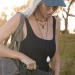 Woman holding a large bag outdoors with a natural background
